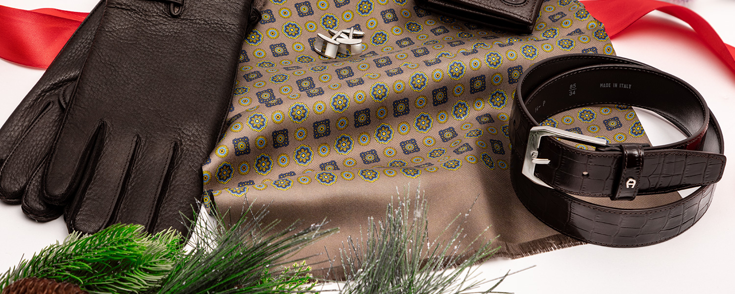 Edles Männer-Geschenkset mit Ledergürtel, schwarzen Handschuhen, Portemonnaie und gemustertem Tuch im eleganten Look.