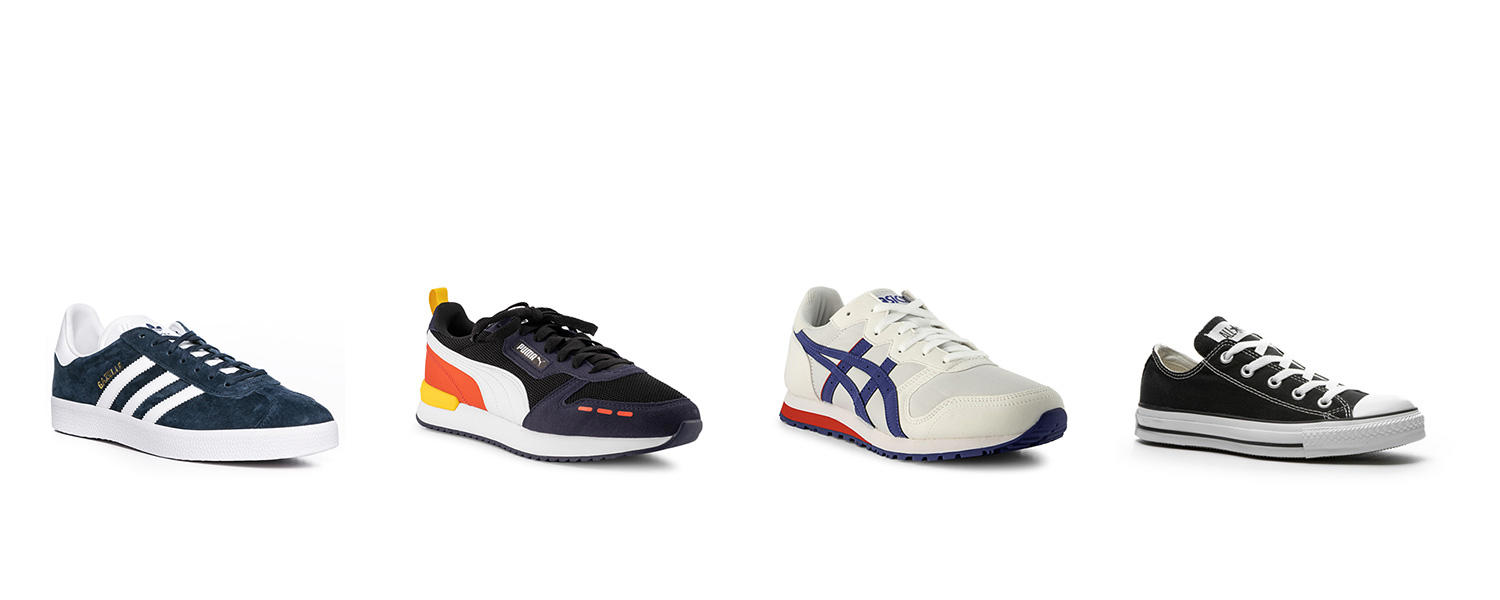 Vier verschiedene Senaker (von links nach rechts): Wildleder-Sneaker in Blau, sportlicher Sneaker in Schwarz/Orange/Weiß, weißer Sneaker und schwarzer Sneaker.