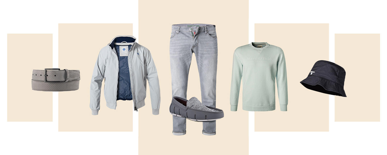 Ein Look bestehend aus grauem Gürtel, Blouson, hellgrauer Jeans, grauen Bootsschuhen, mintfarbenes Sweatshirt und schwarzer Bucket Hat. 