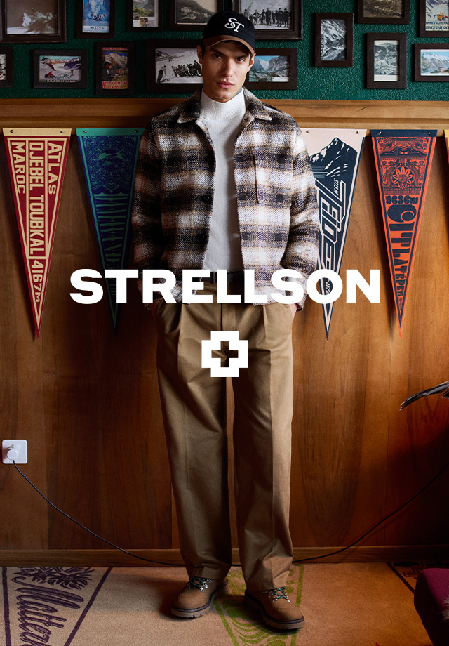 Karierte Wolljacke in Beige-Schwarz, kombiniert mit beigem Rollkragenpullover, lässig präsentiert