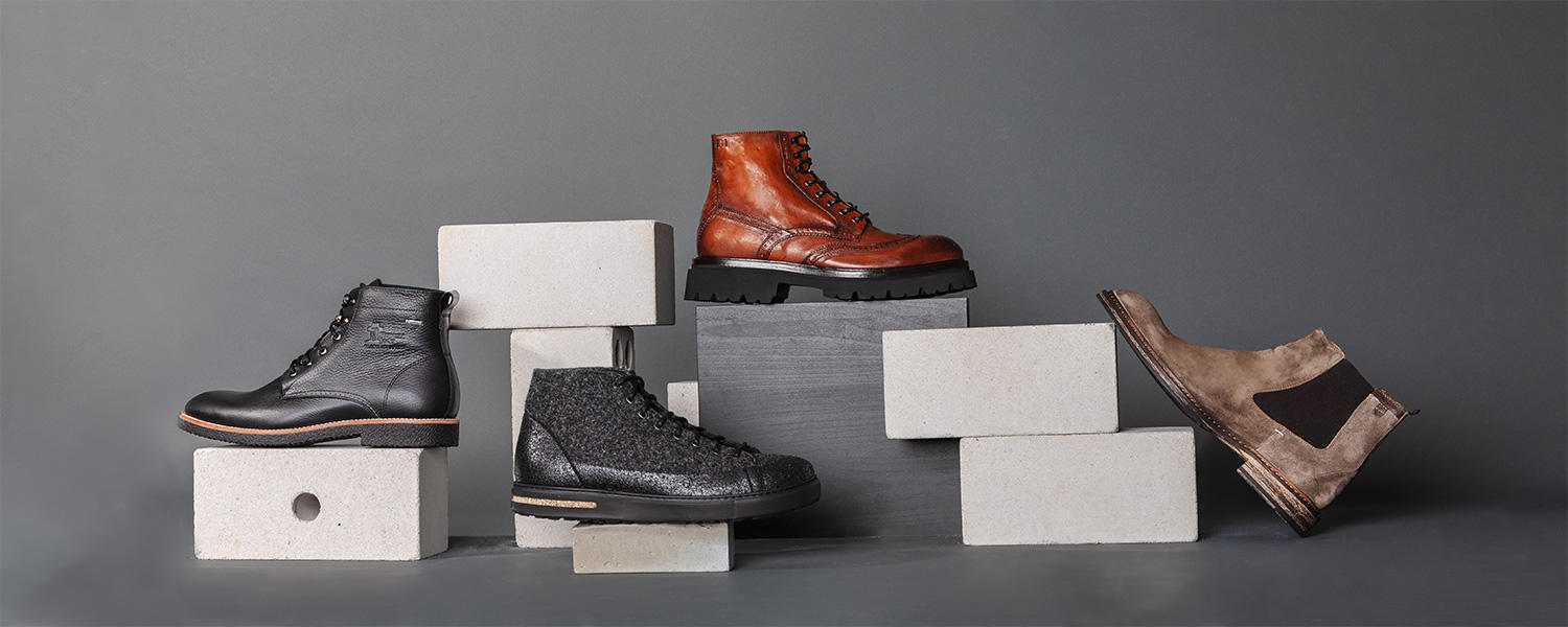 Herrenstiefeletten und Boots aus Leder und Velours in Braun, Grau und Schwarz.