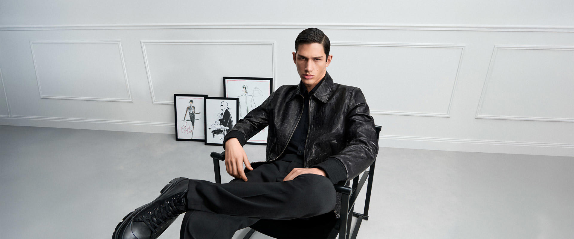 Schwarze Lederjacke im strukturierten Design, kombiniert mit Hemd und Anzughose, moderner All-Black-Look.