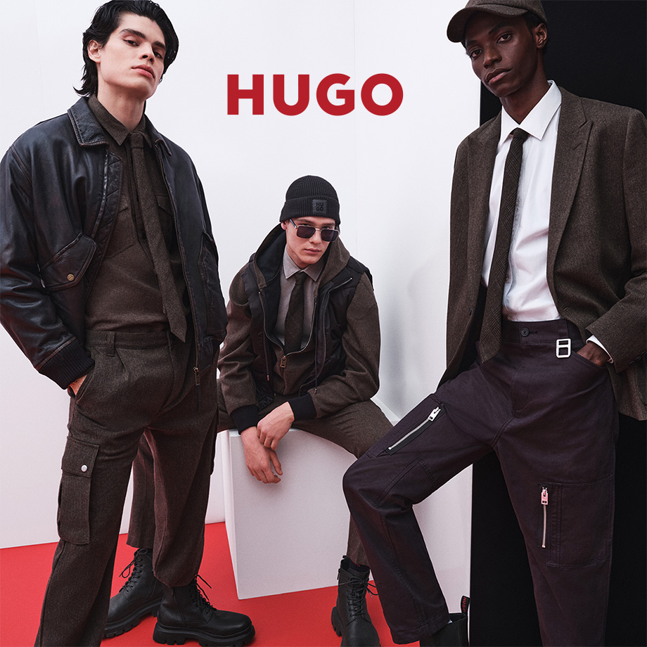 Mehrere Männer in braunen Anzügen und Krawatten, kombiniert mit Accessoires wie Hüten und Sonnenbrillen, lässig präsentiert.