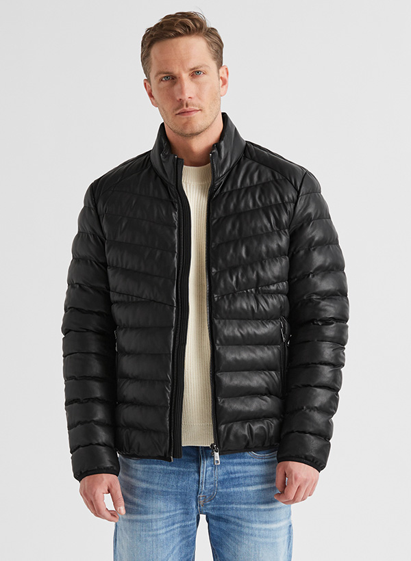 Schwarze Steppjacke aus Synthetik, lässig getragen über weißem Pullover und Jeans