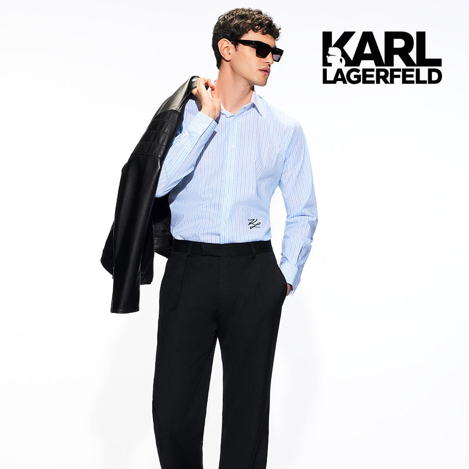 Modebewusster Mann mit Sonnenbrille, Hemd und Jacke über der Schulter – stilvoll präsentiert von KARL LAGERFELD.