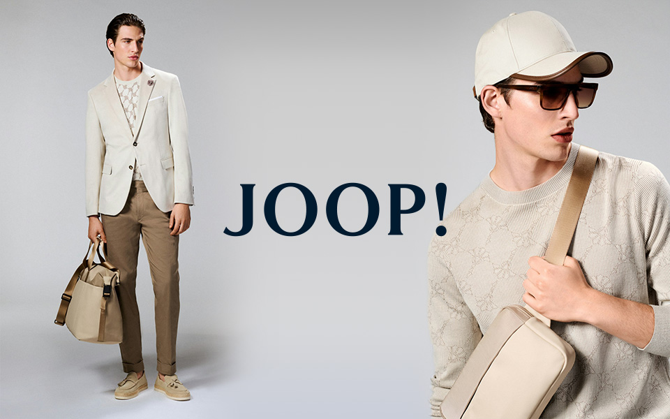 Ein junger Mann vor neutralem Hintergrund in JOOP-Styles, mittiges JOOP-Logo