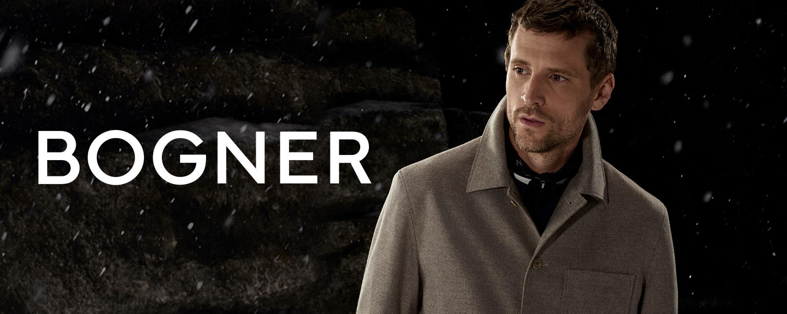 Elegant gekleideter Mann in beigefarbener Jacke von Bogner vor winterlicher Felskulisse – stilvolle Premiummode für Herren mit sportlich-klassischer Note.