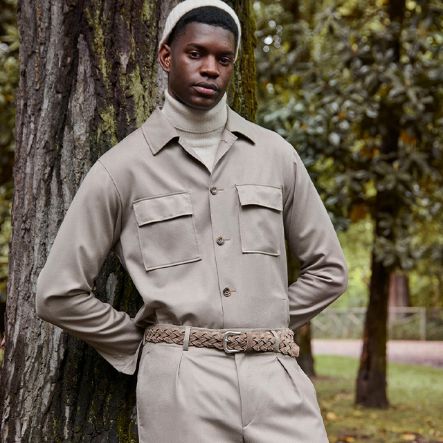 Mann in sandfarbenem Overshirt mit Brusttaschen und passender Hose, kombiniert mit hellem Rollkragenpullover