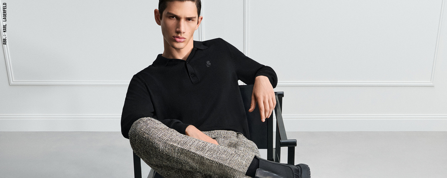 Elegantes Langarm-Poloshirt in Schwarz – edel kombiniert mit gemusterten Stoffhosen.