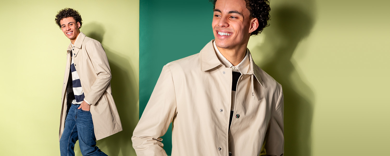 Beigefarbener Mantel in modernem Look – ideal für den Übergang, kombiniert mit Streifenpullover und Jeans.