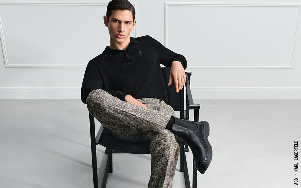Schwarzes Longsleeve-Polo mit gemusterter Stoffhose und Chelsea Boots, moderner Business-Casual-Look.