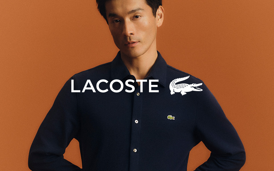 Mann in dunkelblauem Langarm-Poloshirt aus Baumwolle vor orangefarbenem Hintergrund