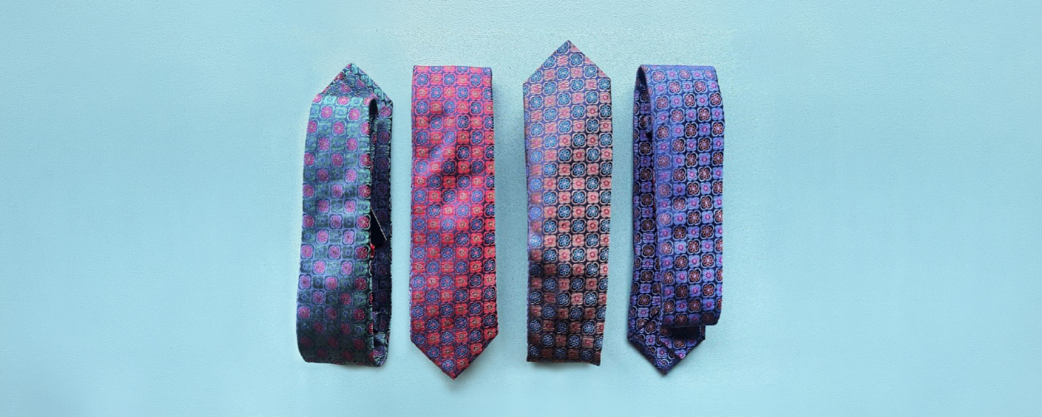 Vier Business-Krawatten mit geometrischem Medaillon-Muster in Blau, Rot und Rosa aus Seide