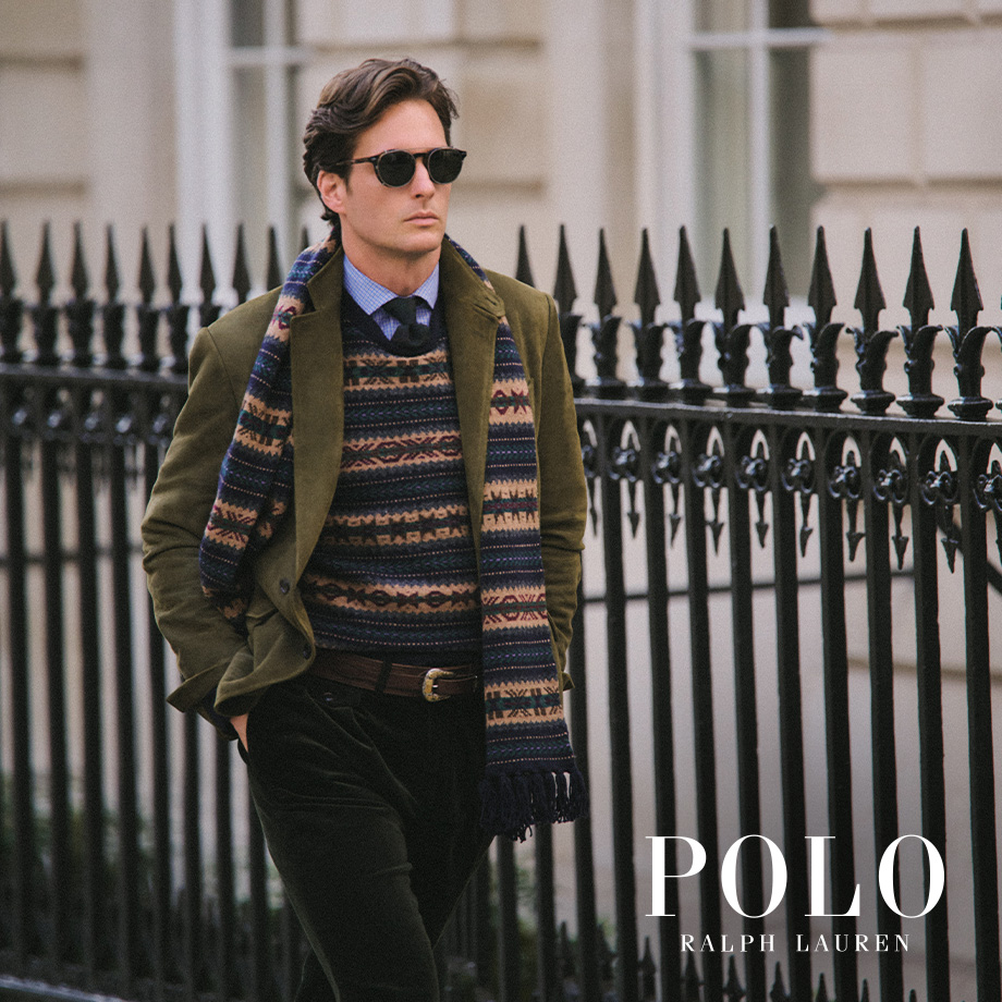 Mann in olivgrünem Sakko mit gemustertem Strickpullover und blauem Hemd, Smart-Casual-Look mit Wollschal