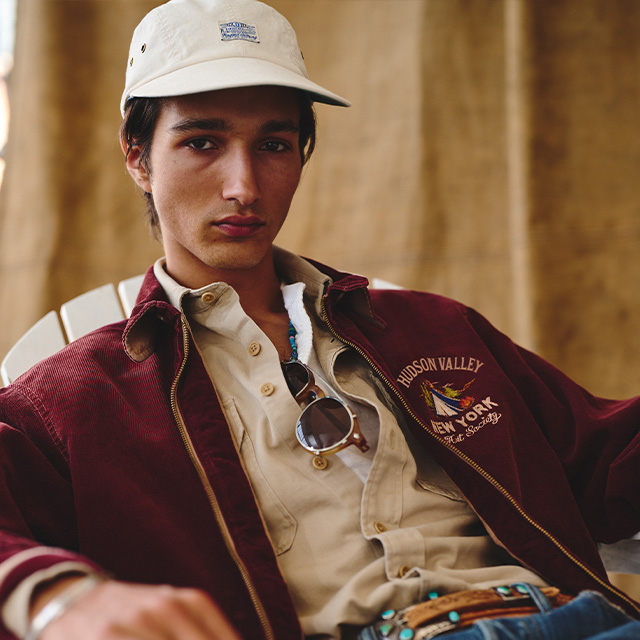 Beiger Freizeit-Hut und cremefarbenes Freizeithemd, getragen mit bordeauxroter Jacke, leger präsentiert