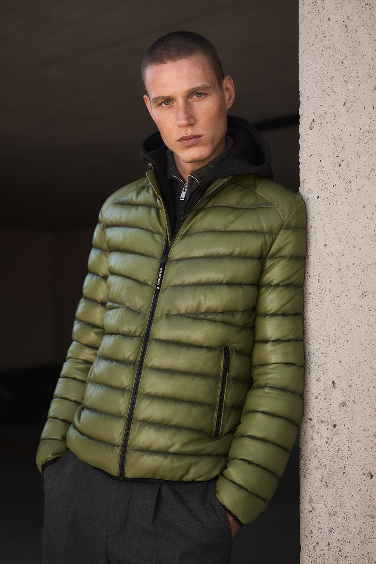Grüne Steppjacke aus Leder, getragen mit Kapuzenpullover, urbaner Stil