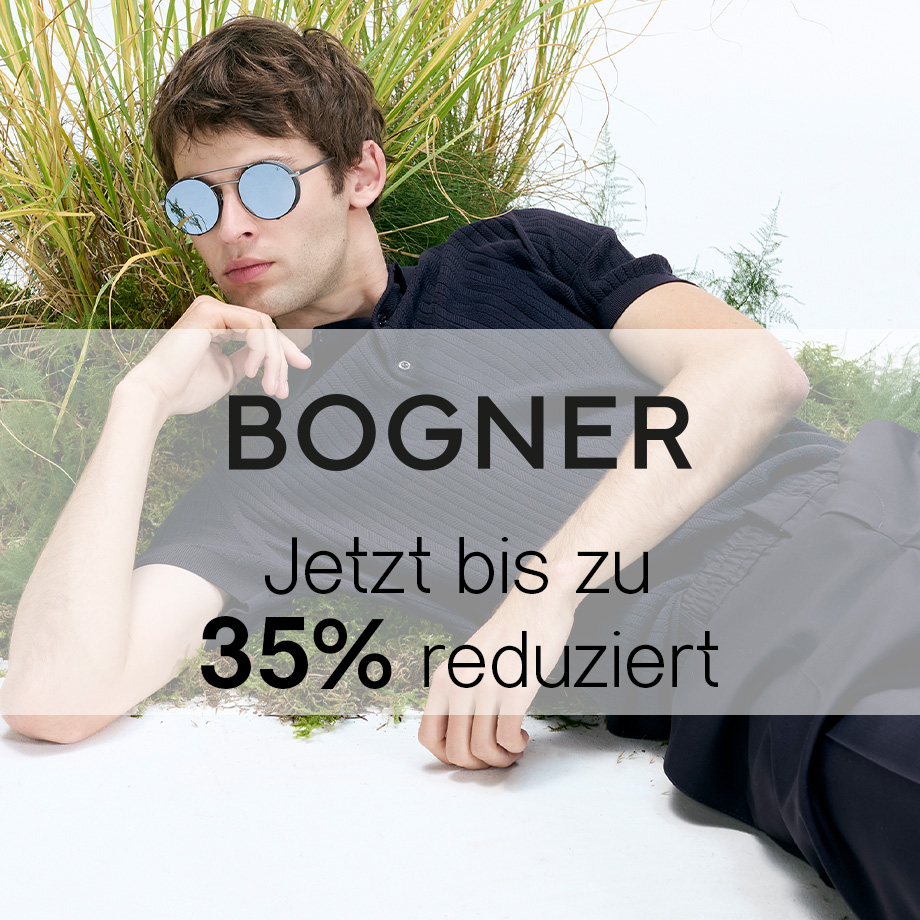 Mann in dunkelblauem Strickpullover liegend, runde Sonnenbrille, lässiger Outdoor-Look