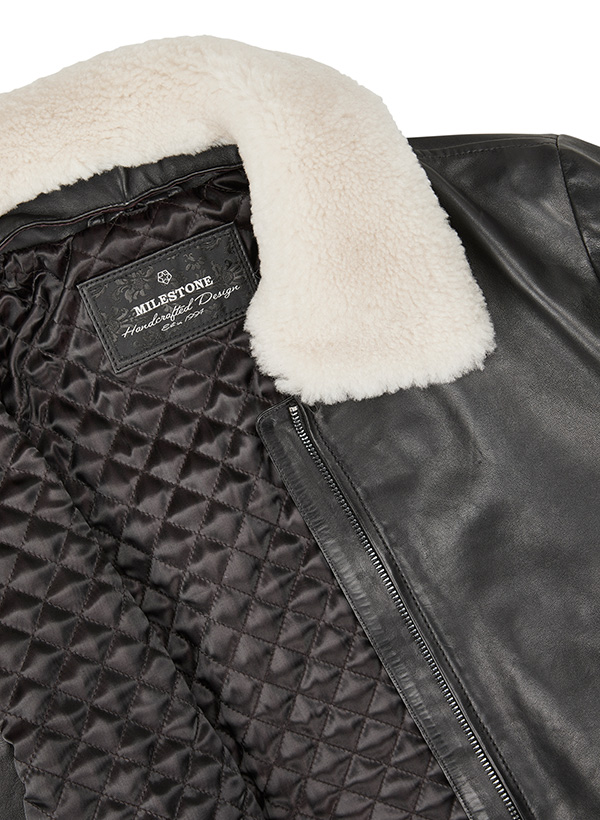 Schwarze Lederjacke mit cremeweißem Shearling-Kragen und gesteppter Innenfutteransicht